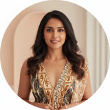 Circular portrait of Ananya Varma, a woman with warm skin and dark hair, smiling and wearing the Aureyra Maxi Dress.